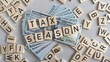 © Svitlana - wooden cube Tax season with dollar money. Tax day concept