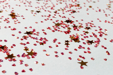 Wall Mural - Gold colored stars and crystals confetti on a blue background. Glowing texture.