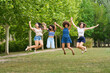 © Retamosa - Four young women are jumping in the air in a park