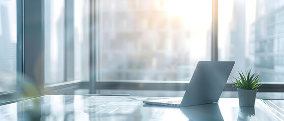 Poster - A laptop sits on a desk in an office lit by the sun.
