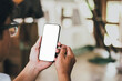 © panitan - cell phone blank white screen mockup.hand holding texting using mobile on desk at office.background empty space for advertise.work people contact marketing business,technology