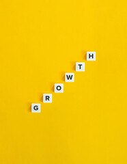 Wall Mural - Growth Word and Banner. The Development Concept of Economics. Letter Tiles on Yellow Background. Minimal Aesthetics.