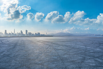 Wall Mural - Asphalt road square and city skyline with modern buildings scenery under the blue sky