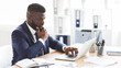 © Prostock-studio - Young afro entrepreneur studying competitors online, using laptop in office, panorama with copy space