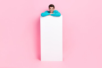 Poster - Full length photo of nice young man lean on banner empty white advert banner dressed stylish blue garment isolated on pink color background
