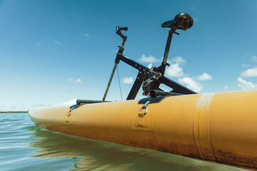 Detail of a water bike stopped near a beach with calm waters
