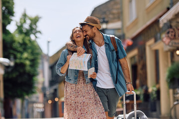 Carefree couple of travelers having fun while going on summer holiday.