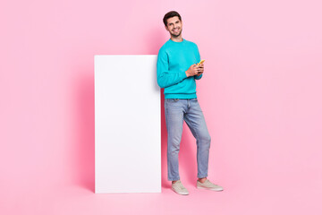 Poster - Full length photo of attractive young man blank copyspace hold device gadget dressed stylish blue outfit isolated on pink color background