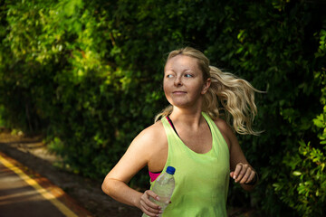 Wall Mural - fitness woman training and jogging in summer park. healthy and sport concept