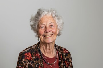 Wall Mural - Portrait of a grinning woman in her 80s smiling at the camera isolated in white background