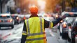 © Pinklife - Back view of a traffic controller with a reflective safety vest giving a stop hand signal on a busy urban road