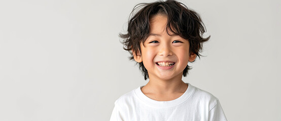 Wall Mural - asian boy smiling with wavy hair and  white t-shirt isolated on white background