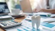 © HQ2X2 - Dental Finance Concept with Tooth Model and Calculator. Dental Insurance Planning with Charts and Tooth Figurine