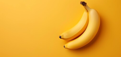 Two bananas on a yellow background