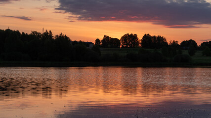 Wall Mural - colorful sunrise, sunset landscape by the lake, brightly colored sky is reflected in the water of the lake