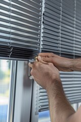 Poster - A person fixing a window roller blind, giving advice on where this image can be used