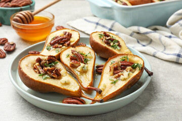 Wall Mural - Tasty baked pears with nuts, blue cheese, thyme and honey on light grey table