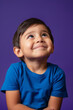 © wolfhound911 - a Hispanic child feeling amused on a purple studio background