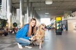 © BillionPhotos.com - transportation of pets. Woman with dog for air travel.