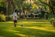 © evgenia_lo - A young boy is playing with a soccer ball in a grassy field