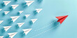 Red paper plane leads a dense group