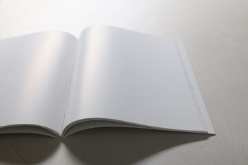 Wall Mural - Open notebook with blank pages on grey textured table, closeup. Mockup for design