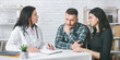 © Prostock-studio - A doctor in a white coat is talking to a couple during a medical consultation in an office. The man is sitting with his head in his hands, while the woman is sitting next to him
