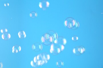 Canvas Print - Beautiful transparent soap bubbles on light blue background