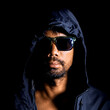 © STOCK PHOTO 4 U - Mysterious Man in Hooded Jacket and Sunglasses Against Black Background