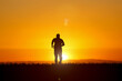 © STOCK PHOTO 4 U - Silhouette of a Person Running at Sunset with Vibrant Orange Sky and Sunlight