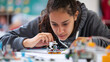 © Luluraschi - Close-up of female student building a robot in stem class, concentration, engineer woman