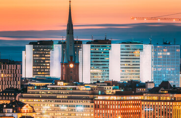 Wall Mural - Stockholm, Sweden. View Of St. Clara Or Saint Klara Church And Houses In Twilight Dusk Lights. Evening Night Lighting