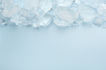 Canvas Print - Pieces of crushed ice on light blue background, top view. Space for text