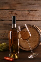 Wall Mural - Glass of wine, bottle, corkscrew, barrel and grapes on wooden table