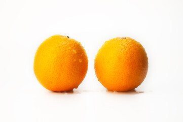 Wall Mural - Two oranges are sitting on a white background