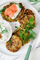 Wall Mural - Zucchini pancakes with sour cream, smoked salmon and dill sauce.top veiw