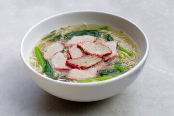 Chinese egg noodles with red pork in hot soup