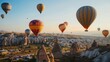 © Nijat - Amazing balloons in flight over a stone landscape in Cappadocia, Turkey