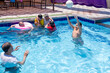 © Viga - portrait for family friend ad relatives in the pool having wounderful time together taking photos and smiling , playing ball in the pool and having greate time