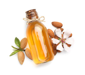 Wall Mural - Bottle of almond oil, fresh nuts and beautiful flower isolated on white, top view