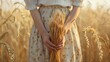 © Joyce - Closeup view of hand of a beautiful female holding wheat ear in field.