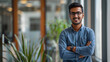 © ZenArt - Young Indian businessman in modern office with arms crossed