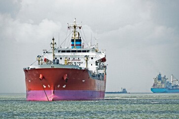 ocean cargo ships in galveston bay waiting for entrance into the port of houston ship channel.