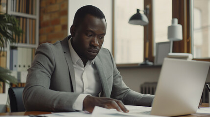 Poster - portrait of a man working with business documents with a laptop on the table in modern office, business analysis research 