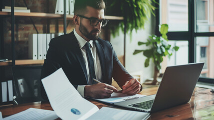 Poster - portrait of a man working with business documents with a laptop on the table in modern office, business analysis research 