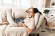 © SHOTPRIME STUDIO - Smiling Woman Using Laptop for Online Freelance Work in Cozy Living Room