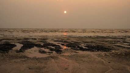 Sticker - Timelapse of dramatic sunset with orange sky in a cloudy day at a beach.