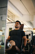 © Gatot - Man focused on training legs on the machine in the gym
