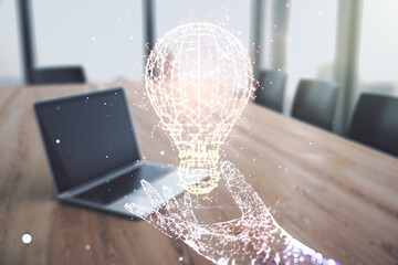 Poster - Creative light bulb hologram on modern laptop background, idea concept. Multiexposure