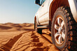 © Emanuel - 4x4 vehicle driving over sand dunes, representing the popular sport of dune bashing in the Arabian desert